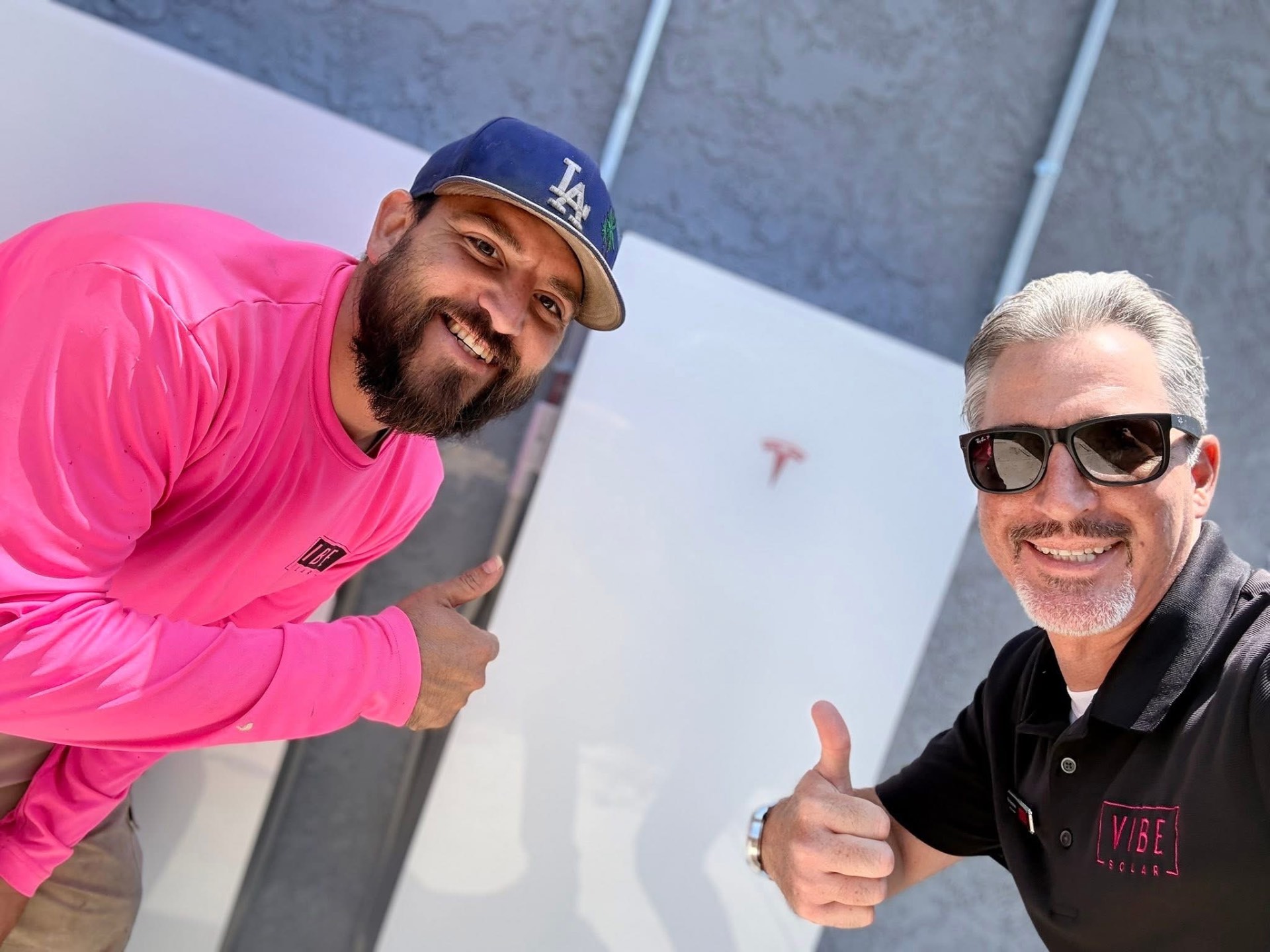 Vibe Solar team members giving a thumbs up on the job